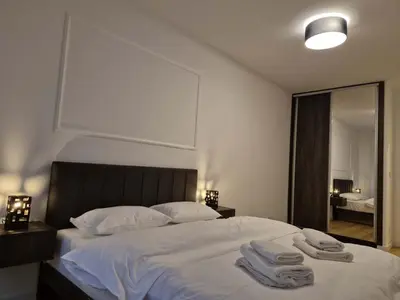 a bedroom with a large bed with towels on it at Park Vila New Luxury apartments with garage in Belgrade