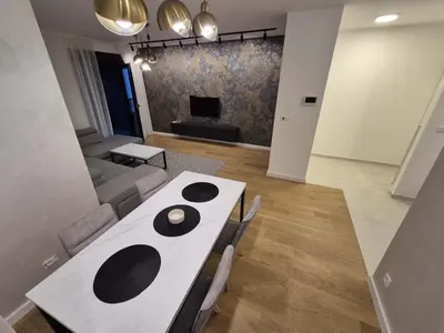 a living room with a table and a couch at Park Vila New Luxury apartments with garage in Belgrade