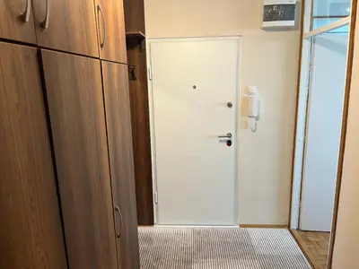 a room with a white door and a door at Comfort & Style Panoramic Urban Retreat in Novi Beograd