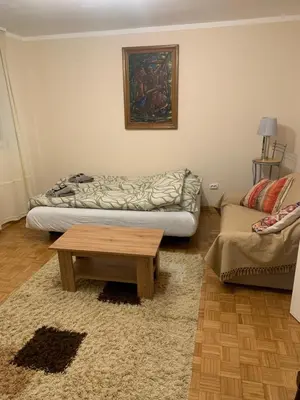 a living room with a couch and a coffee table at Comfort & Style Panoramic Urban Retreat in Novi Beograd