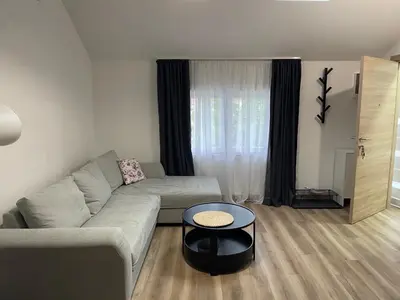 a living room with a couch and a table at Apartment Magnolia gallery in Zemun