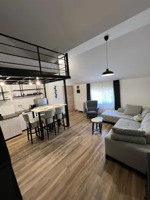 a living room with a couch and a table at Apartment Magnolia gallery in Zemun