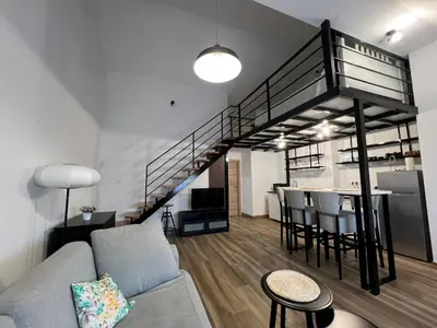 a living room with a couch and a loft at Apartment Magnolia gallery in Zemun