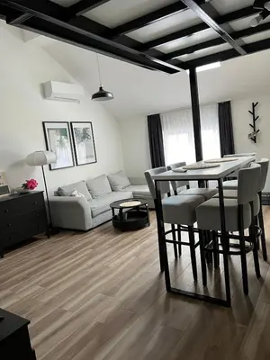 a living room with a table and a couch at Apartment Magnolia gallery in Zemun