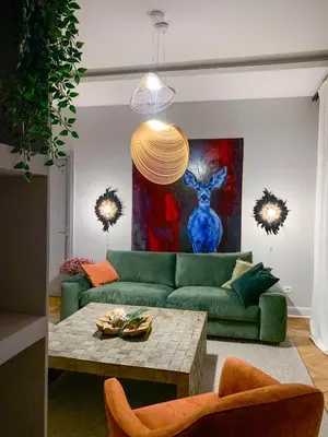 a living room with a green couch and a table at Pop's Apartments in Belgrade