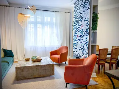 a living room with a couch and chairs and a table at Pop's Apartments in Belgrade