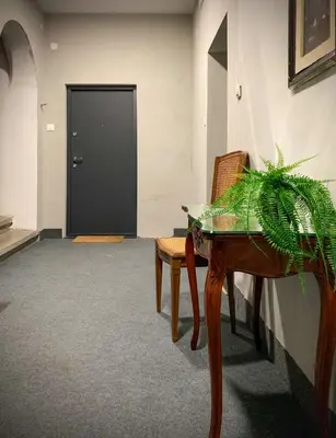 a room with a table and a plant and a door at Pop's Apartments in Belgrade