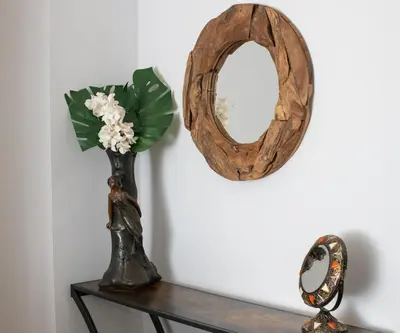 a vase of flowers on a table with a mirror at Pop's Apartments in Belgrade