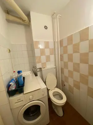 a small bathroom with a toilet and a washing machine at Stay4day in Kijevo