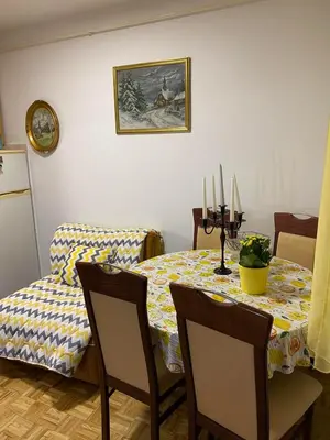 a dining room with a table and chairs with candles on it at Stay4day in Kijevo