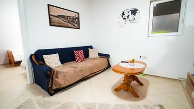 a living room with a couch and a table at Skyline Suites Belgrade in Ledine