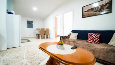 a living room with a couch and a table at Skyline Suites Belgrade in Ledine