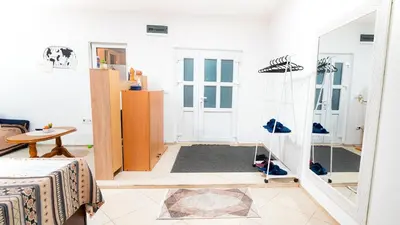a room with a mirror and shoes on the floor at Skyline Suites Belgrade in Ledine