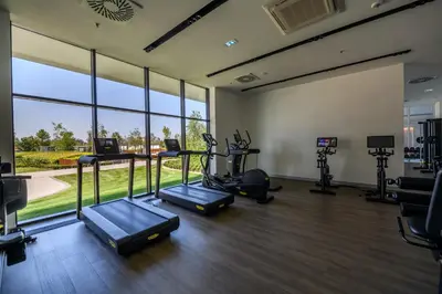 a gym with cardio equipment and a large window at Luxury apartment with Pool&Gym in Belgrade