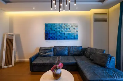 a living room with a blue couch and a table at Luxury apartment with Pool&Gym in Belgrade