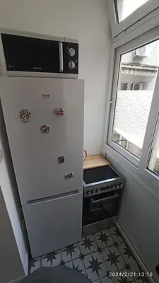 a kitchen with a stove and a microwave at Stan na dan Beograd in Karaburma