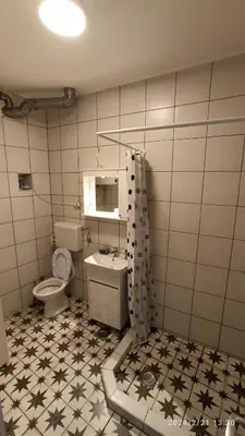 a bathroom with a toilet and a sink at Stan na dan Beograd in Karaburma