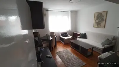 a living room with a couch and a table at Stan na dan Beograd in Karaburma