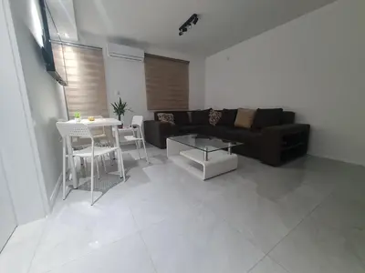 a living room with a couch and a table at Marash apartman - stan na dan in Belgrade