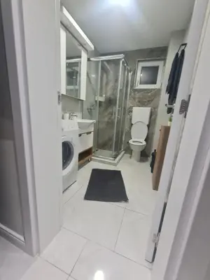 a bathroom with a toilet and a glass shower at Marash apartman - stan na dan in Belgrade