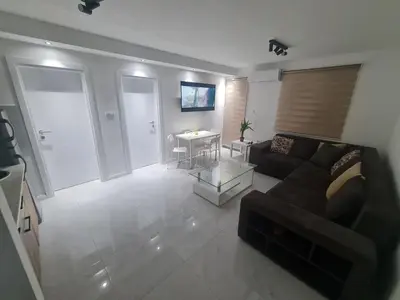 a living room with a couch and a table at Marash apartman - stan na dan in Belgrade