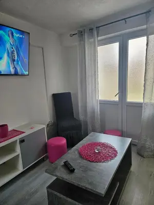 a living room with a table and a chair at MM apartman in Mladenovac