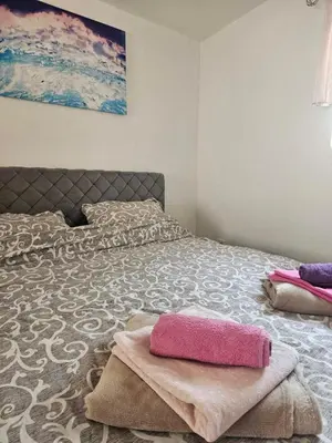 a bedroom with a bed with two towels on it at MM apartman in Mladenovac
