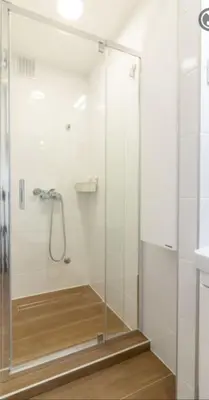 a shower with a glass door in a bathroom at yubc in Novi Beograd