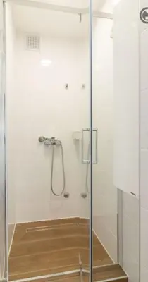 a shower with a glass door in a bathroom at yubc in Novi Beograd