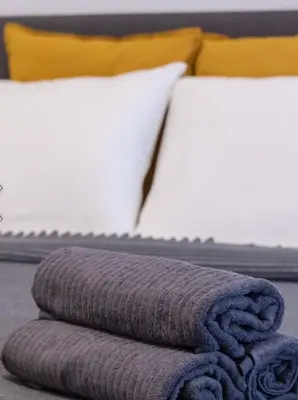 a pile of towels sitting on top of a bed at yubc in Novi Beograd