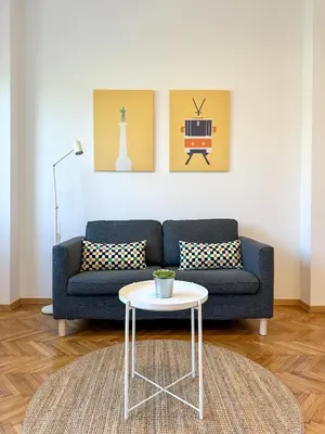 a living room with a blue couch and a table at Apartment 5A - Experience true Belgrade! in Belgrade