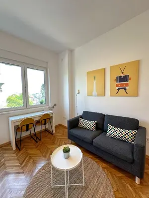a living room with a couch and a table at Apartment 5A - Experience true Belgrade! in Belgrade