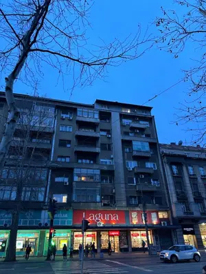 a building with a car parked in front of it at Apartment 5A - Experience true Belgrade! in Belgrade