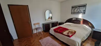 a bedroom with a bed with a red pillow on it at Beautiful large villa Vrčin in Vrčin