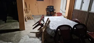 a room with a table and chairs and a stove at Beautiful large villa Vrčin in Vrčin