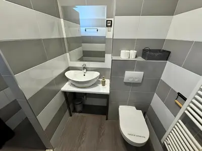 a small bathroom with a toilet and a sink at Nomad Hostel in Belgrade