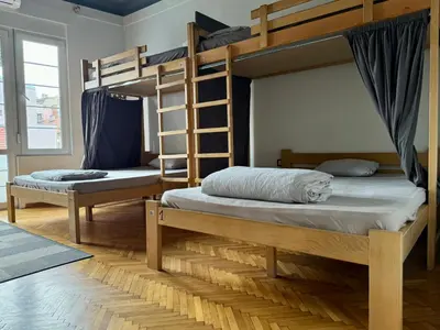 two bunk beds are in a room with at Nomad Hostel in Belgrade