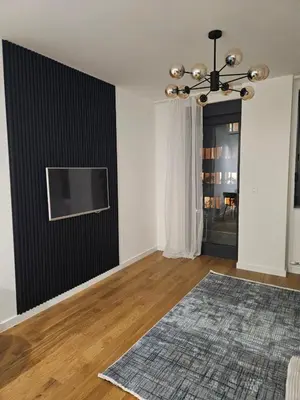 a living room with a flat screen tv on a wall at Luxury new apartment in Belgrade in Belgrade