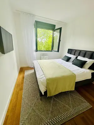 a bedroom with a large bed and a window at Luxury new apartment in Belgrade in Belgrade