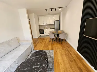a living room with a couch and a table with chairs at Luxury new apartment in Belgrade in Belgrade
