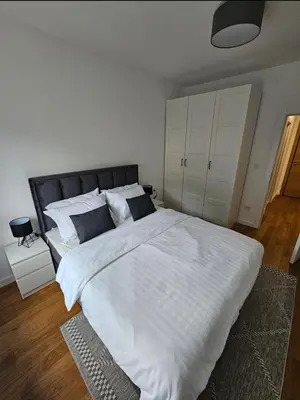 a bedroom with a large bed with white sheets and pillows at Luxury new apartment in Belgrade in Belgrade