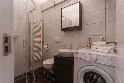 a bathroom with a washing machine and a sink at MaKi apartment in Belgrade