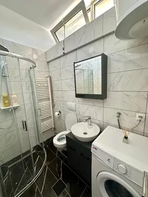 a bathroom with a sink and a washing machine at MaKi apartment in Belgrade
