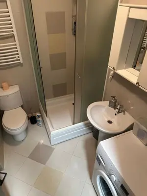 a bathroom with a shower and a toilet and a sink at Studio Charlie Aviv Park in Mirijevo
