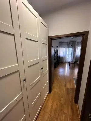 a room with white closet doors and a hallway at Studio Charlie Aviv Park in Mirijevo