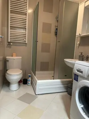 a bathroom with a shower and a toilet and a sink at Studio Charlie Aviv Park in Mirijevo