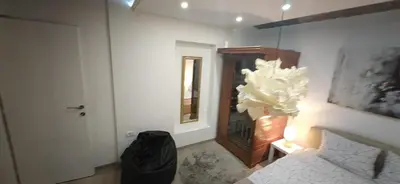 a bedroom with a bed and a window and a mirror at Uno in Belgrade