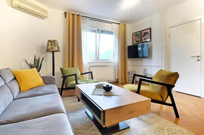 a living room with a couch and a coffee table at Downtown nest Apartment in Belgrade