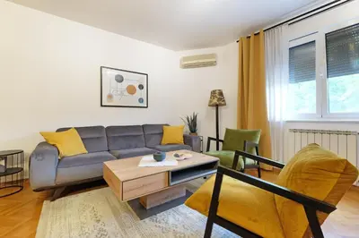 a living room with a couch and chairs at Downtown nest Apartment in Belgrade
