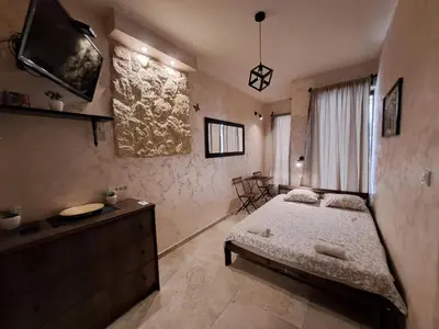 a bedroom with a bed and a dresser at Retro studio in Zemun